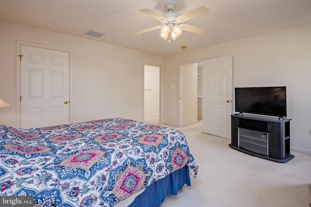 bedroom with baseboards, a ceiling fan, visible vents, and light colored carpet