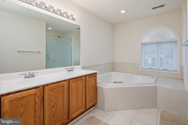 full bath featuring a stall shower, a sink, a bath, and tile patterned floors