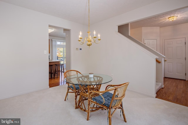 dining area with carpet, stairs, and baseboards