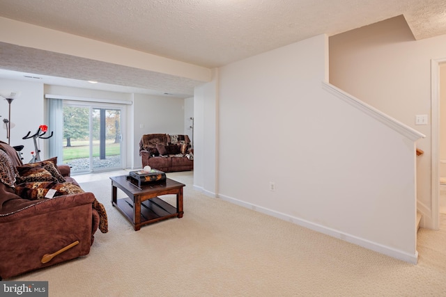 carpeted living room with stairs, baseboards, and a textured ceiling