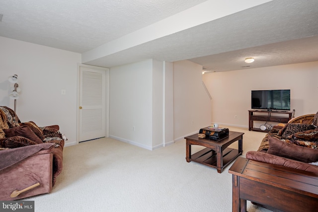 living room featuring light carpet, a textured ceiling, and baseboards