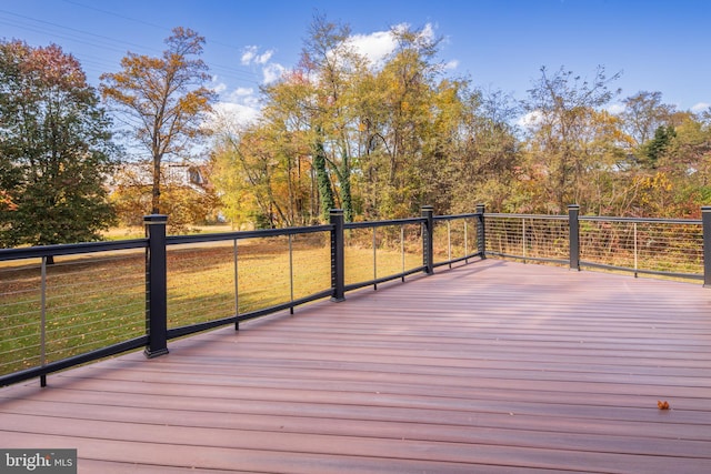 wooden deck with a lawn