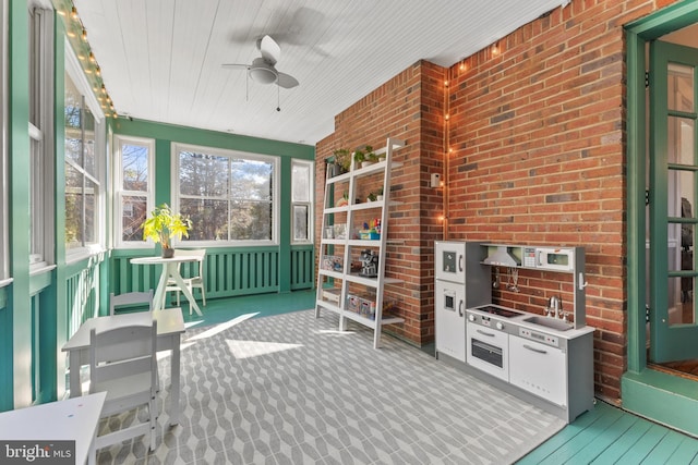 sunroom / solarium featuring ceiling fan and wooden ceiling