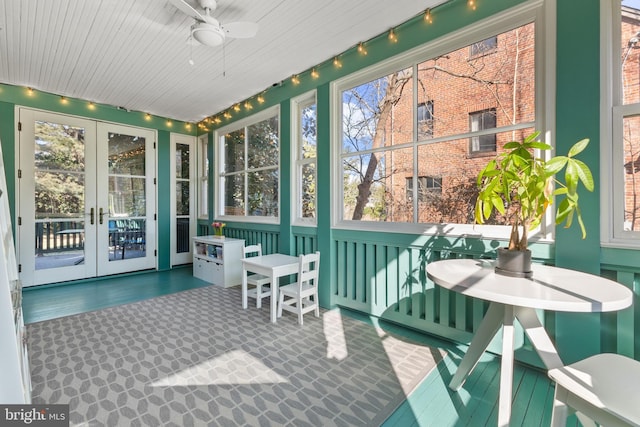 sunroom / solarium with a ceiling fan, french doors, and rail lighting