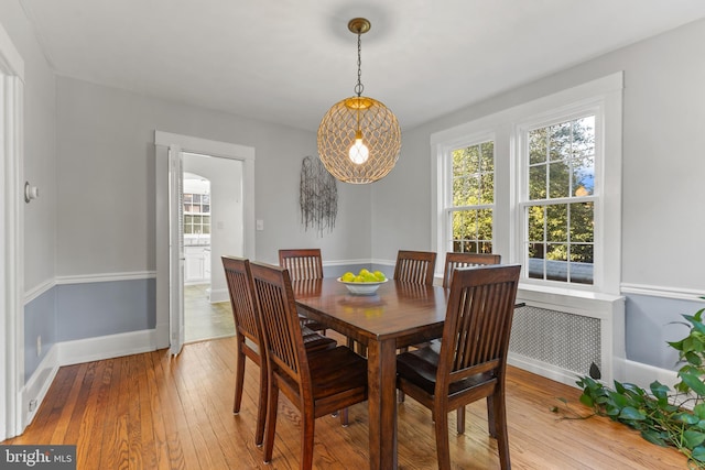 dining room featuring light wood-type flooring and baseboards