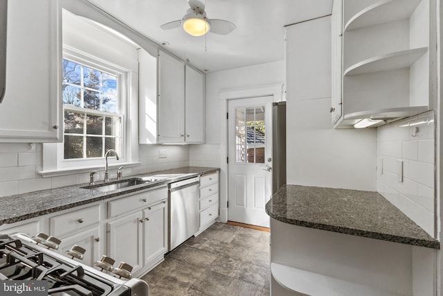 kitchen with white cabinets, open shelves, dark stone counters, and stainless steel appliances