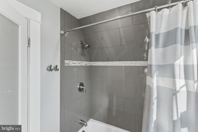 bathroom with shower / bath combo with shower curtain