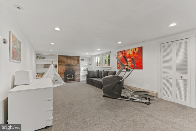 workout area featuring carpet, built in shelves, a baseboard heating unit, and recessed lighting