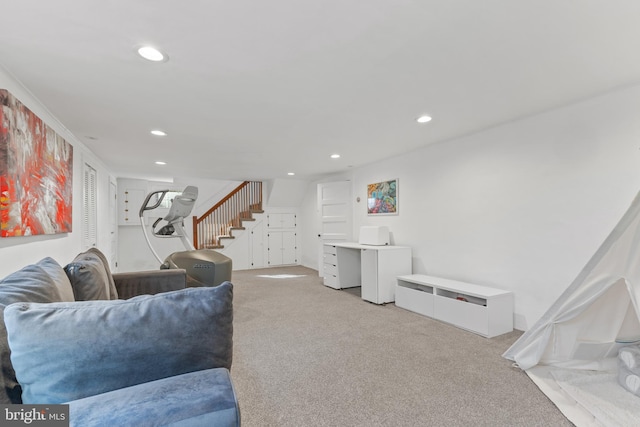 living area featuring recessed lighting, light carpet, and stairway