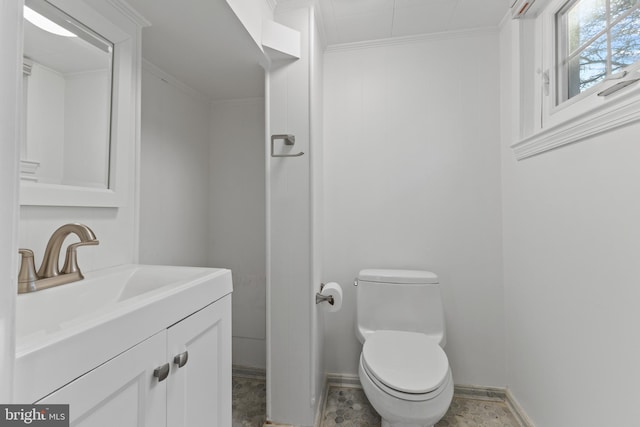 half bath with baseboards, crown molding, vanity, and toilet