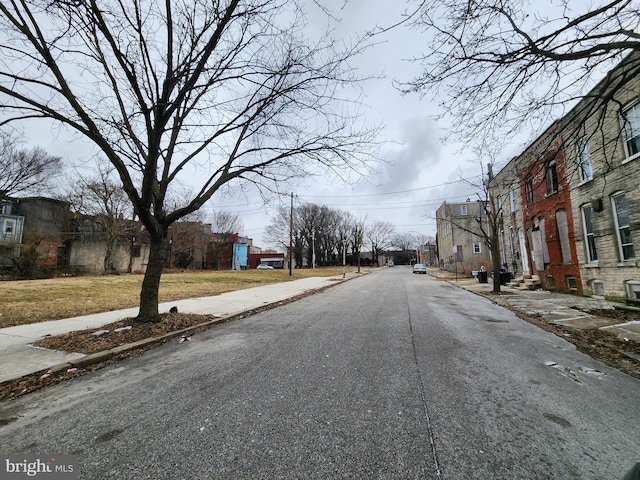 view of road featuring curbs, sidewalks, and a residential view