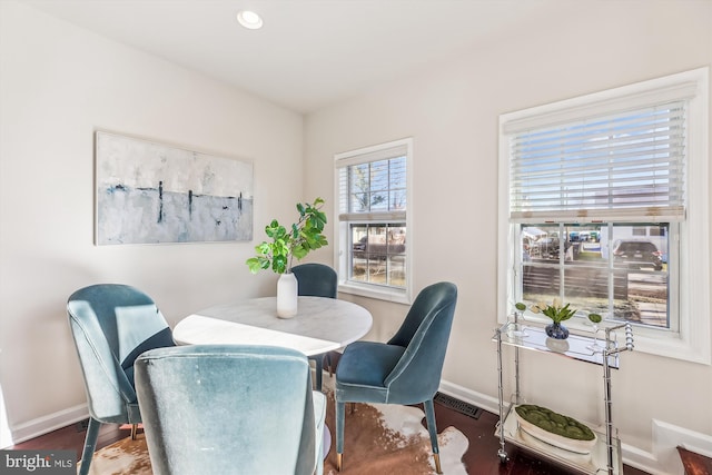 dining room with dark wood-style floors, baseboards, visible vents, and recessed lighting