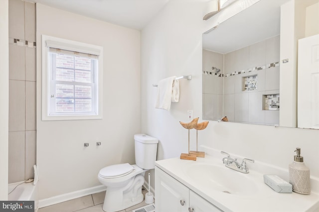 bathroom featuring tile patterned flooring, baseboards, vanity, and toilet