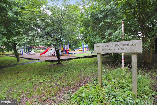 view of community featuring playground community and a yard