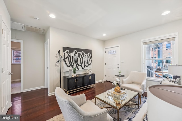 living area featuring dark wood-style floors, baseboards, attic access, and recessed lighting