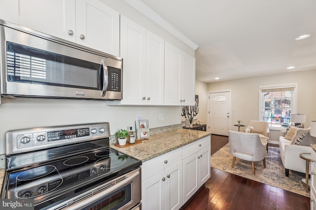 kitchen with dark wood-style flooring, recessed lighting, appliances with stainless steel finishes, white cabinetry, and light stone countertops