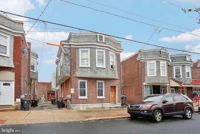 victorian home with brick siding and central AC