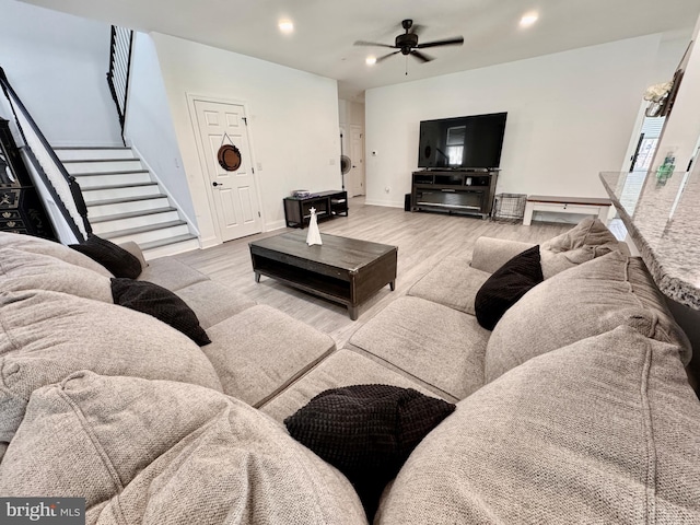 living room with baseboards, a ceiling fan, stairway, wood finished floors, and recessed lighting