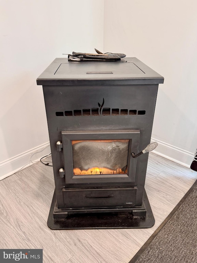 room details with a fireplace, baseboards, and wood finished floors