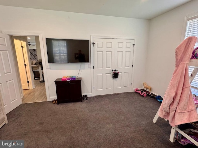 interior space featuring carpet flooring and baseboards