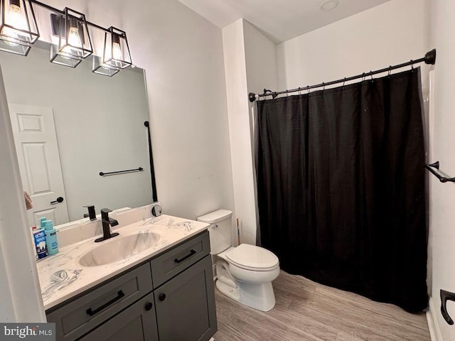 full bathroom with vanity, wood finished floors, toilet, and a shower with curtain