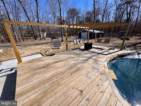 wooden deck featuring an outdoor structure