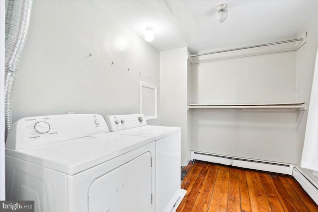 laundry room featuring washer and dryer, laundry area, a baseboard radiator, and wood finished floors