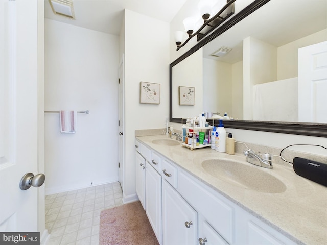 full bathroom featuring visible vents, a sink, and double vanity