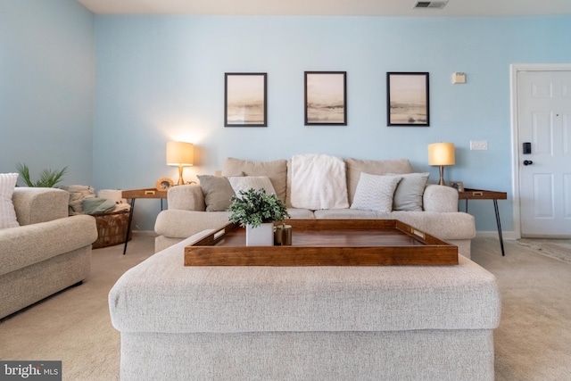 living room with light colored carpet, visible vents, and baseboards