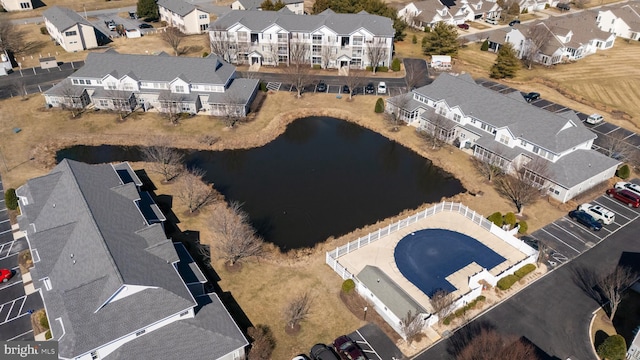 birds eye view of property featuring a water view and a residential view