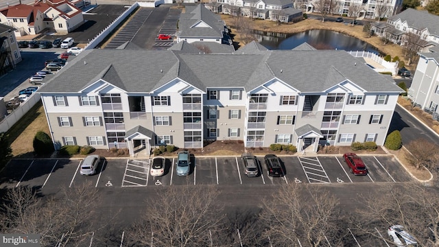 bird's eye view with a water view and a residential view