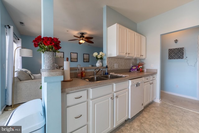 kitchen with tasteful backsplash, visible vents, white cabinets, a sink, and dishwasher