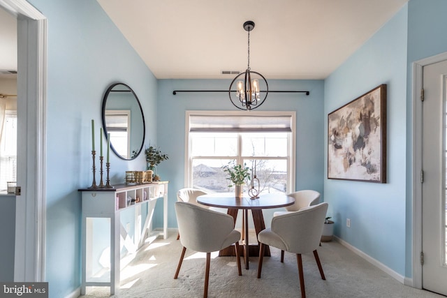 dining room featuring baseboards, carpet flooring, visible vents, and a notable chandelier