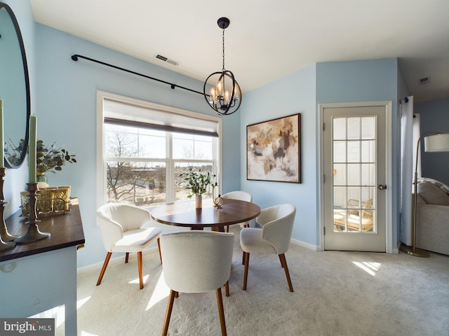 dining area with baseboards, light colored carpet, visible vents, and an inviting chandelier