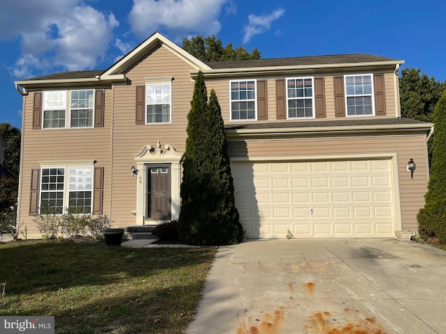 view of front of home with driveway, a garage, and a front yard