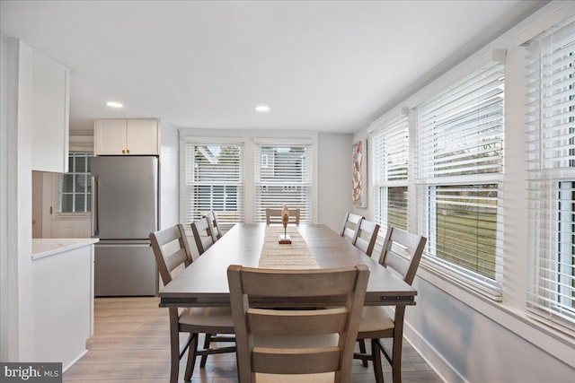 dining space with baseboards, light wood-style flooring, and recessed lighting