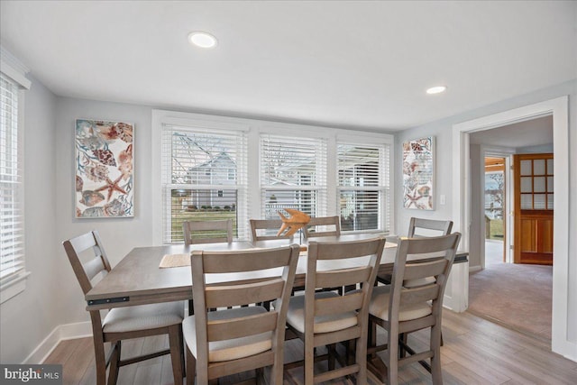 dining area with light wood-style floors, recessed lighting, and baseboards