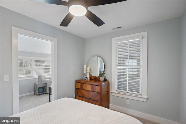 bedroom featuring carpet floors, baseboards, visible vents, and a ceiling fan