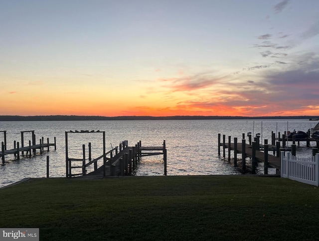 dock area featuring a water view and a yard