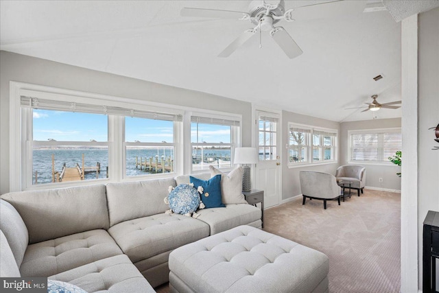 living room featuring light colored carpet, vaulted ceiling, baseboards, and ceiling fan