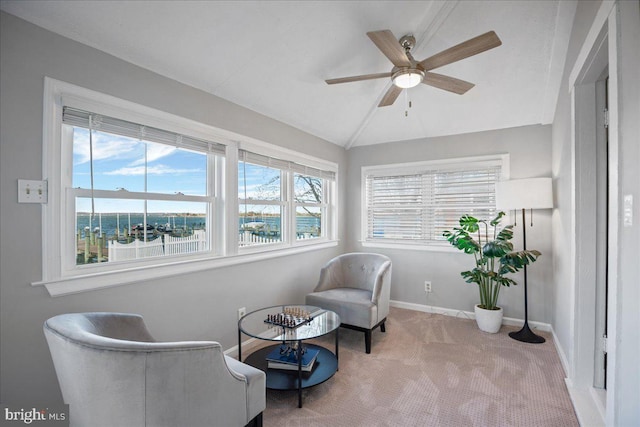 sitting room with a wealth of natural light, carpet, vaulted ceiling, and baseboards