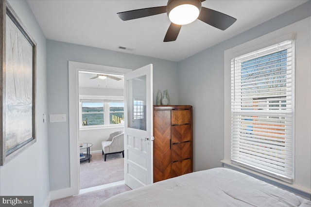 bedroom with carpet floors, a ceiling fan, visible vents, and baseboards