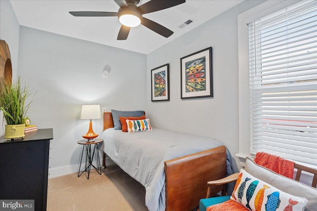 bedroom featuring baseboards, visible vents, ceiling fan, and carpet flooring