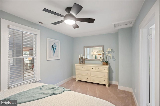 bedroom with light carpet, attic access, visible vents, and baseboards