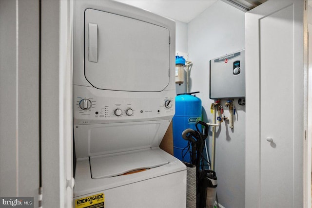 washroom featuring stacked washer and dryer and laundry area