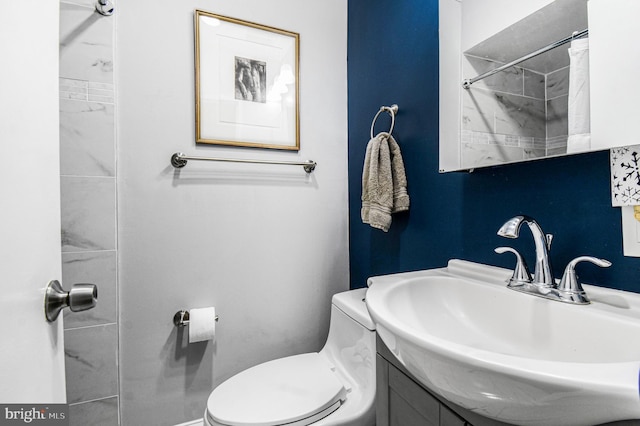 bathroom featuring vanity and toilet