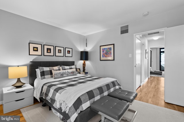 bedroom with visible vents and light wood-style flooring