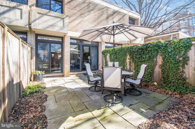 view of patio / terrace with outdoor dining space and a fenced backyard