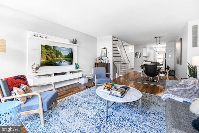 living area featuring stairway and wood finished floors