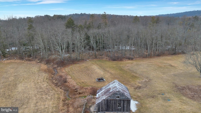 birds eye view of property with a view of trees